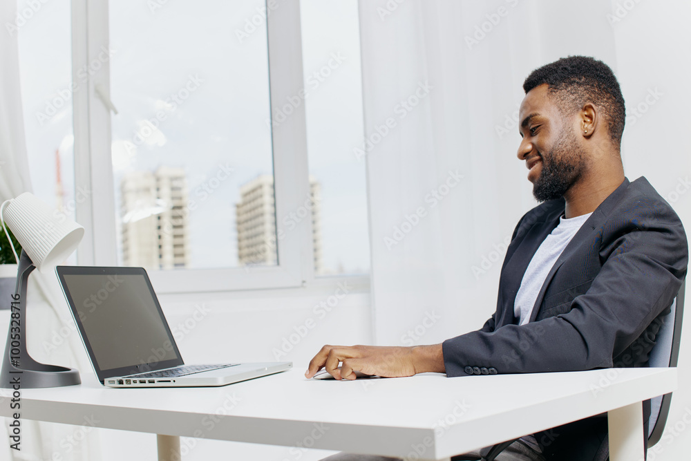 Business professional working on laptop at office desk Business professional working on laptop at office desk