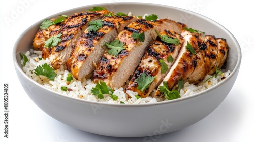 Delicious grilled chicken served on a bed of fluffy rice, garnished with fresh herbs for a mouthwatering meal.