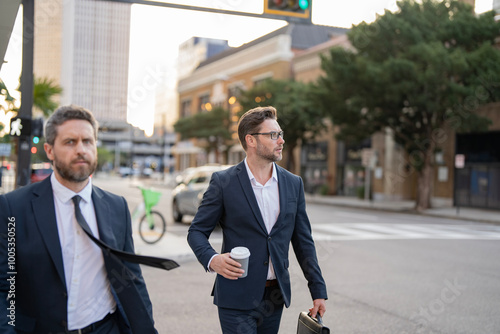 Two successful business men walking outdoor. Businessmen go to work. Business talking. Two businessmen in elegant business suit. Walking colleague. Colleague and friends. Copy space