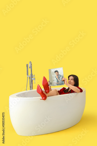 Beautiful woman reading mag...