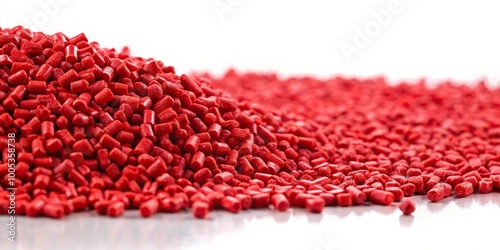 Red plastic polymer granules on white background