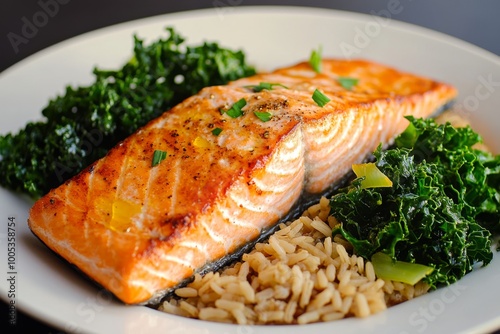 A light and balanced meal with baked salmon, steamed kale, and brown rice, drizzled with olive oil for a nutritious and wholesome dish.