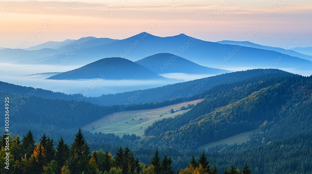 Obraz premium Misty morning view of mountain ranges with blue skies.