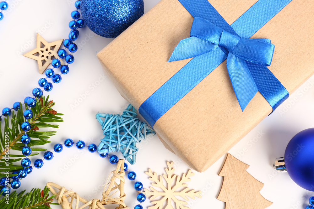 Gift box with Christmas balls, beads, fir tree branches and decorations on white background Gift box with Christmas balls, beads, fir tree branches and decorations on white background