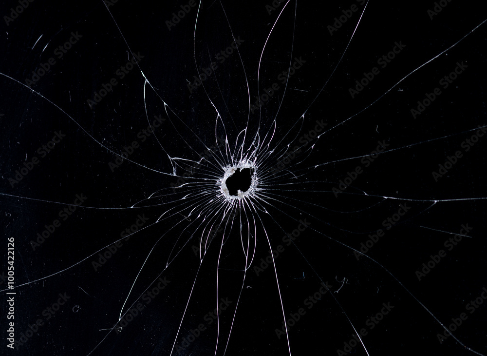 Obraz premium Broken glass bullet holes isolation on black background,Cracked glass