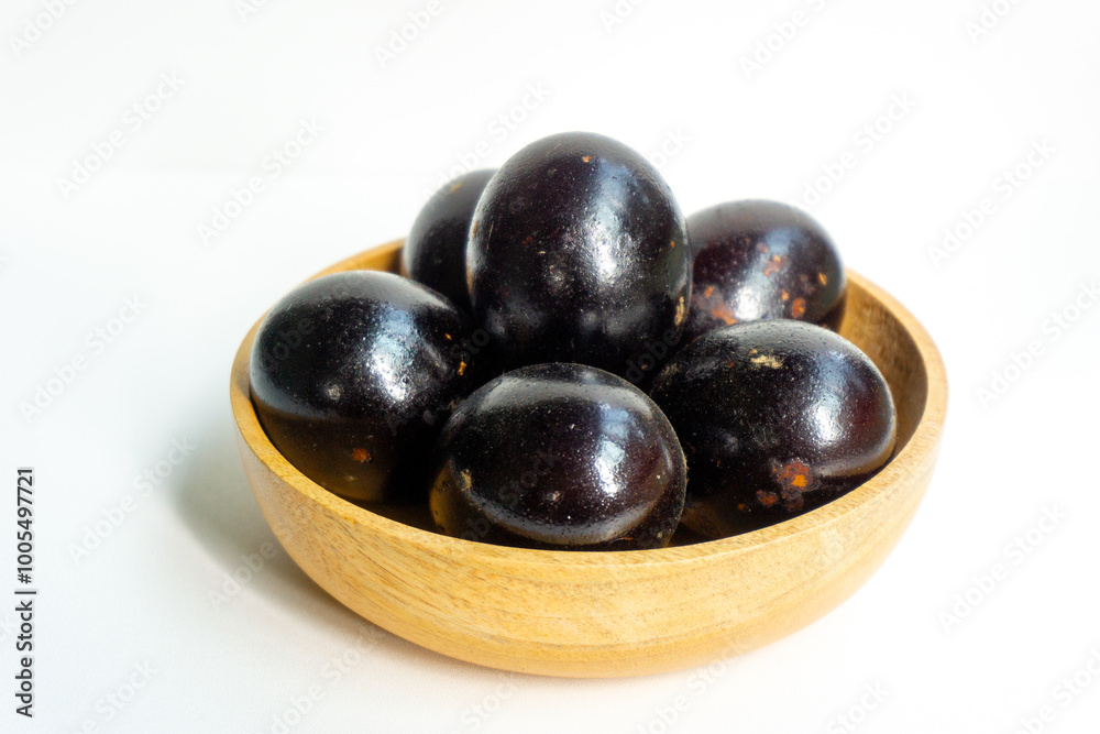 Grilled salted eggs on wooden bowl. Salted eggs are usually made from duck eggs fermented with ash and salt. Grilled salted eggs on wooden bowl. Salted eggs are usually made from duck eggs fermented with ash and salt.