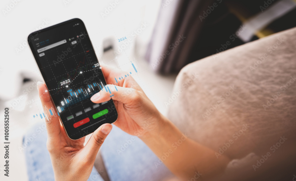 The younger generation is using smartphone with trader is showing a growing virtual hologram stock. Business concept The younger generation is using smartphone with trader is showing a growing virtual hologram stock. Business concept