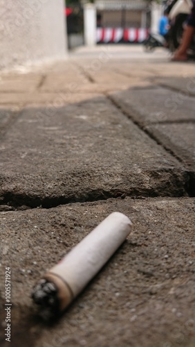 close up of a Cigarette Butt Trash on Paving Block 