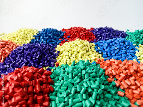 colorful masterbatch granules, polymer resin granules, plastic pigment raw material granules lined up like sand dunes isolated on white background, for industrial plastic company profile design