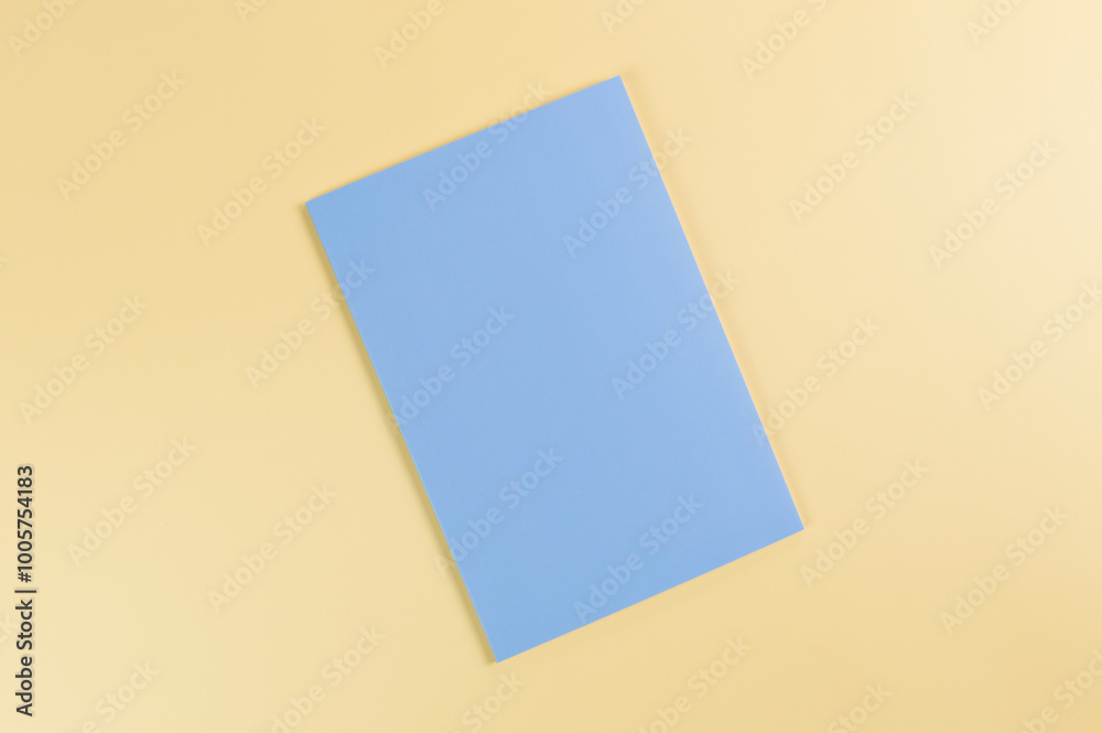 Top view of blue notebook on yellow background. School, office wallpaper. Flat lay, copy space. Top view of blue notebook on yellow background. School, office wallpaper. Flat lay, copy space.