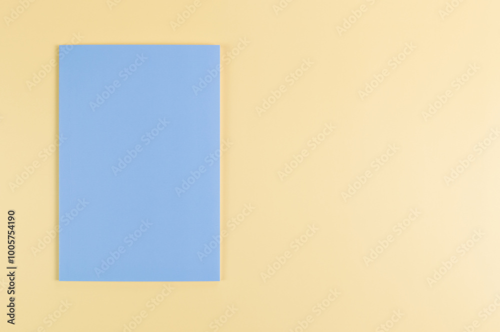 Top view of blue notebook on yellow background. School, office wallpaper. Flat lay, copy space. Top view of blue notebook on yellow background. School, office wallpaper. Flat lay, copy space.