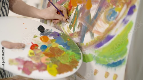 Wallpaper Mural Art therapy in psychology, closeup view of paintbrush in artist hand and canvas. Painter applying bright colors on paper sheet, drawing abstract style picture in workshop, hobby, passion, profession Torontodigital.ca