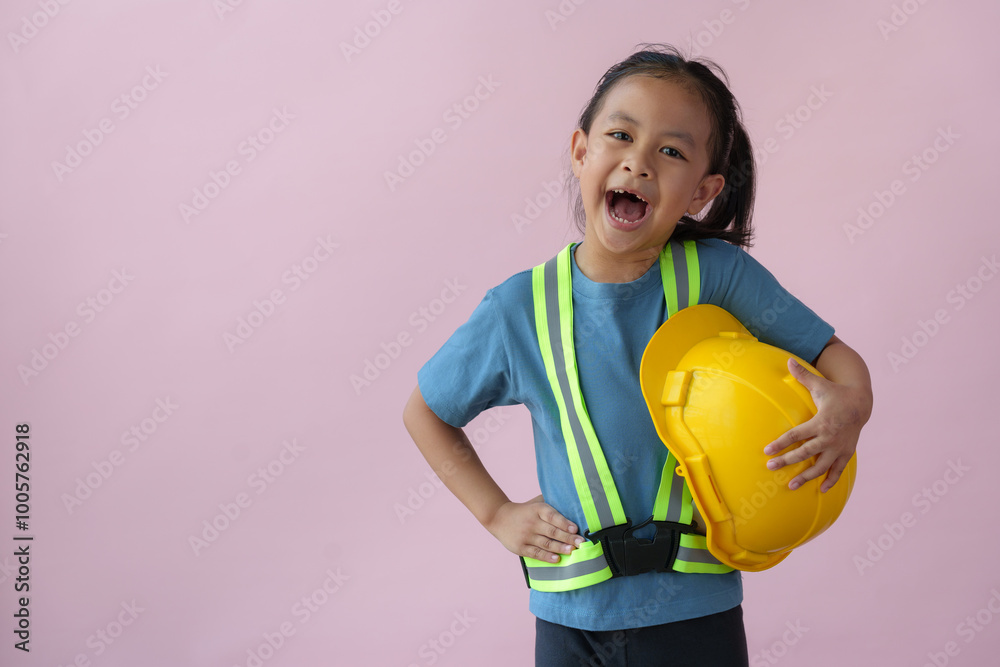 Female engineer, a little girl standing, smiling, holding a yellow helmet. Repairman. Construction engineer. The dream career of young Asian girls in the future. Female engineer, a little girl standing, smiling, holding a yellow helmet. Repairman. Construction engineer. The dream career of young Asian girls in the future.