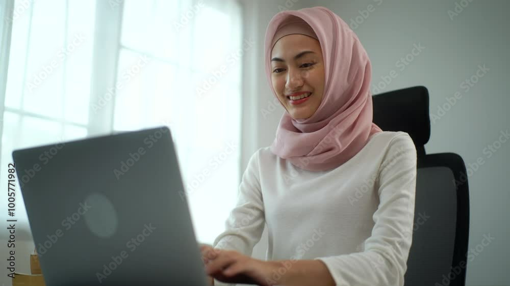Side view of happy young asian muslim business woman in hijab working on laptop and confidently looking at camera in office white room, smiling beautiful female entrepreneur typing computer keyboard.
Side view of happy young asian muslim business woman in hijab working on laptop and confidently looking at camera in office white room, smiling beautiful female entrepreneur typing computer keyboard.