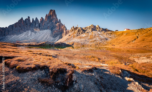 Paterno peak reflected in the Calm waters of Piani lake. Sunny autumn view of Dolomite alps. Gorgeous morning scene of Tre Cime Di Laveredo National Park, Italy, Europe. Travel the world..