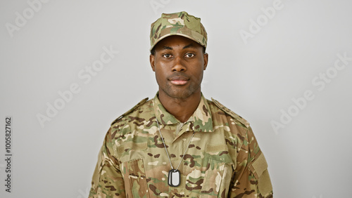 Portrait of a confident young adult black man wearing military camouflage against a white background