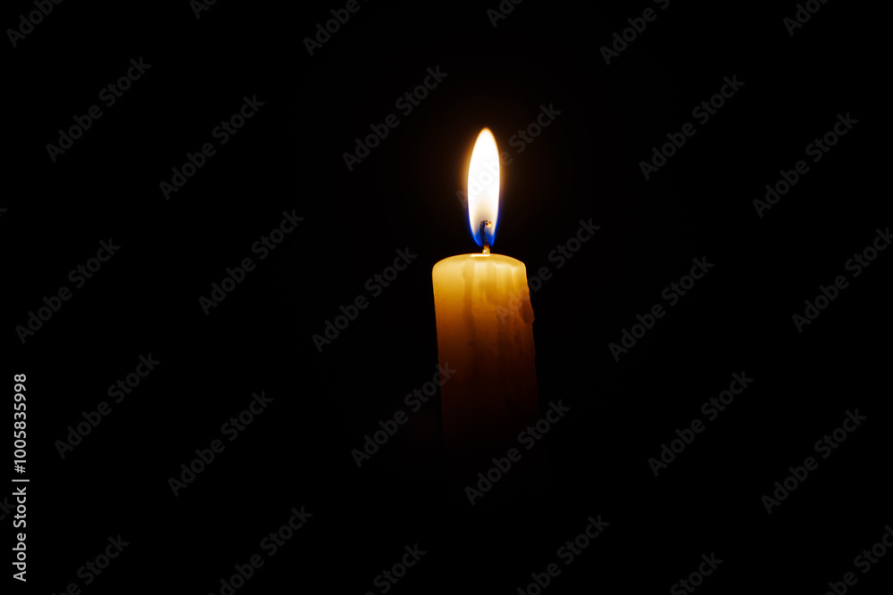 Close-up single candle burning on dark black background, candle fire flame light. Close-up single candle burning on dark black background, candle fire flame light.