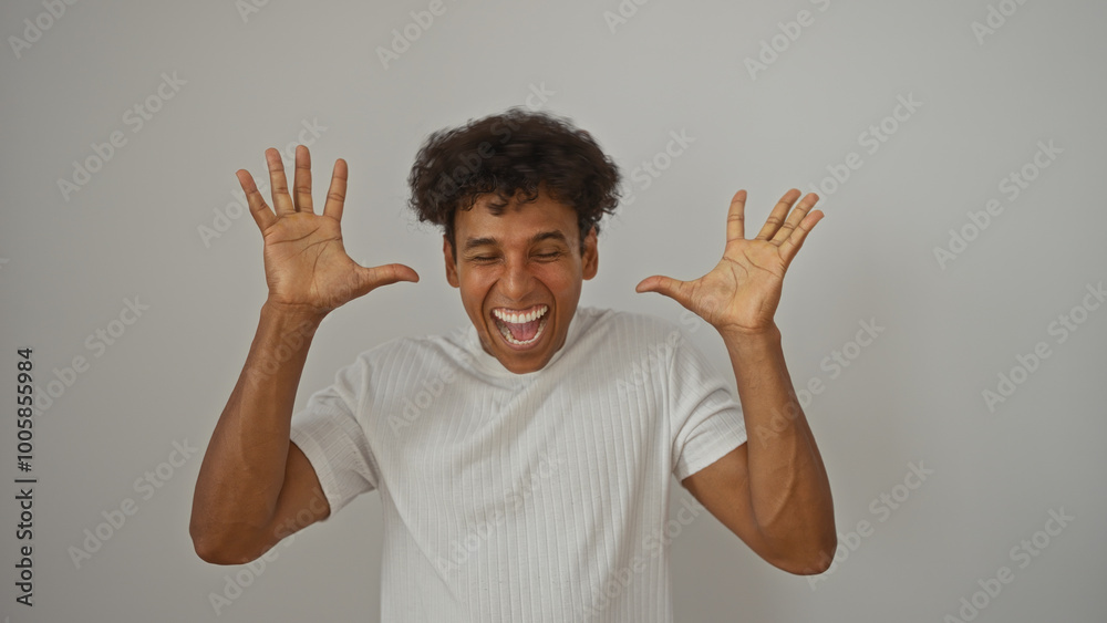Young hispanic man expressing joy with hands up isolated against white background Young hispanic man expressing joy with hands up isolated against white background