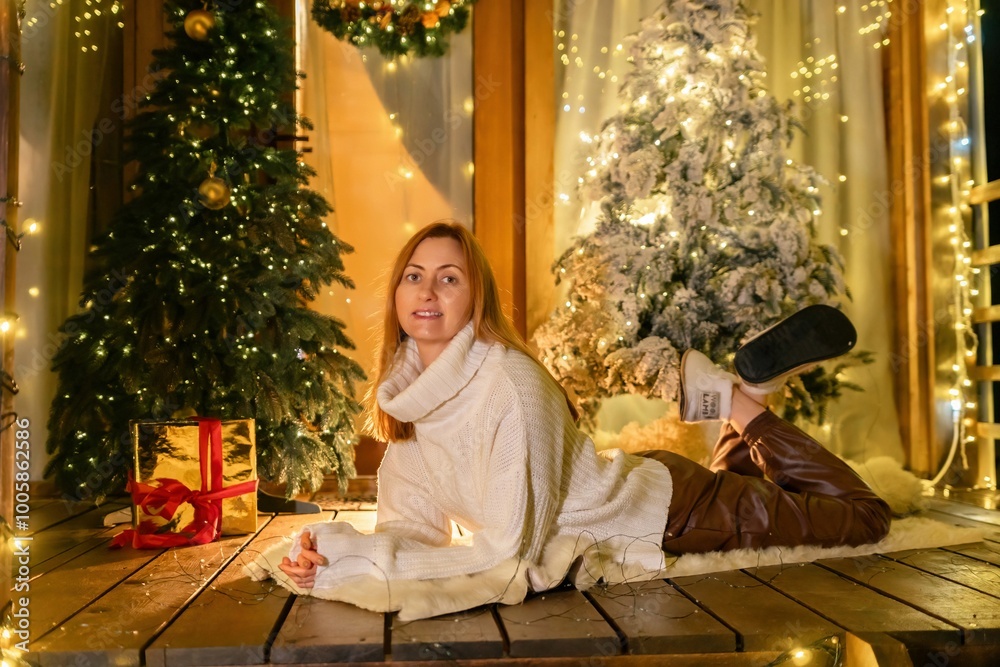 Woman Christmas Tree Lights - Woman lying on wooden floor in front of a decorated Christmas tree. Woman Christmas Tree Lights - Woman lying on wooden floor in front of a decorated Christmas tree.