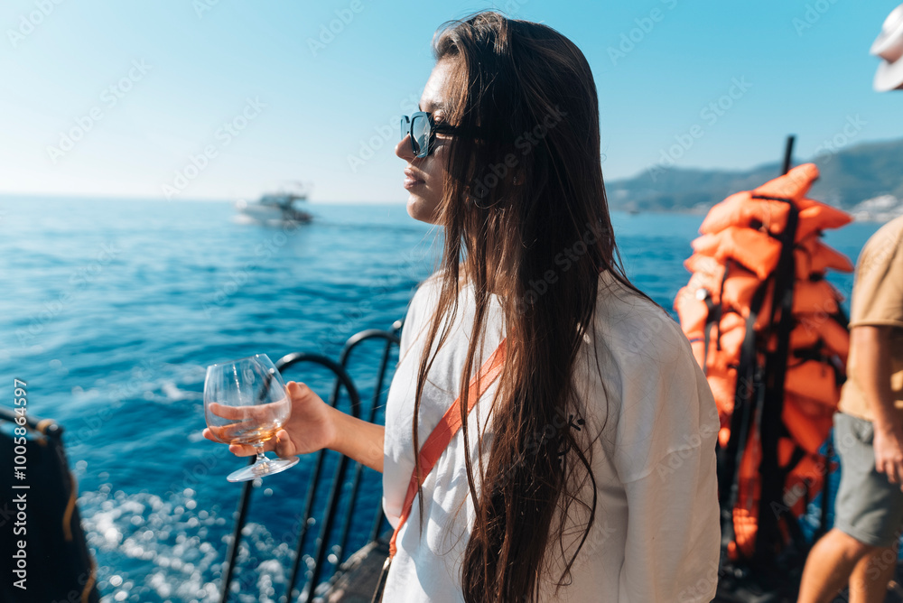 Fototapeta premium Enjoy a Serene Yacht Experience while savoring a Refreshing Beverage on the water
