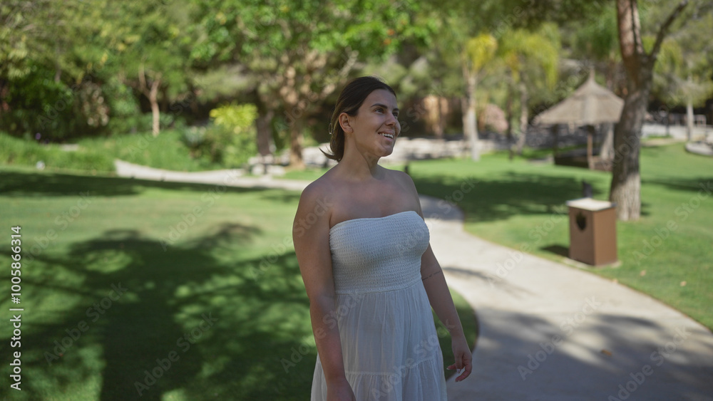 A smiling young woman in a casual white dress enjoying a sunny day at a luxurious indonesian resort with lush greenery. A smiling young woman in a casual white dress enjoying a sunny day at a luxurious indonesian resort with lush greenery.