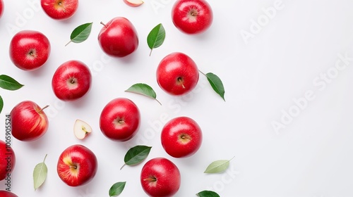 Bunch of red apples with green leaves in the background. The apples are arranged in a row and are of different sizes