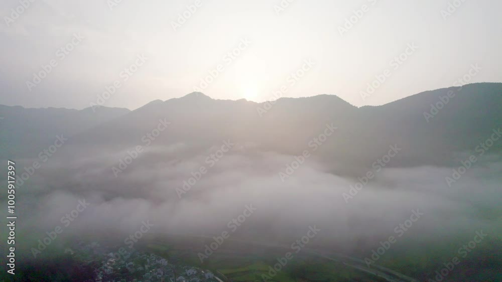 Drone view of agriculture rice fields and local Hui style buildings in Hongguan, Wuyuan, Jiangxi, China. Aerial view of villages in misty morning, high angle view 4k real time footage b roll shot.