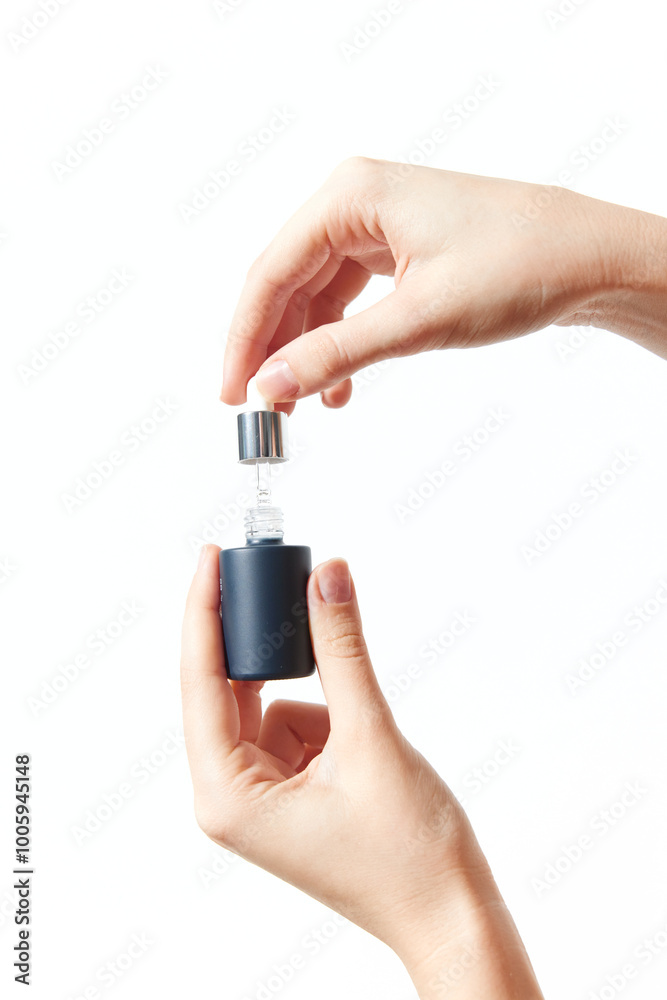 Hand holding small bottle with cap on it Hand holding small bottle with cap on it