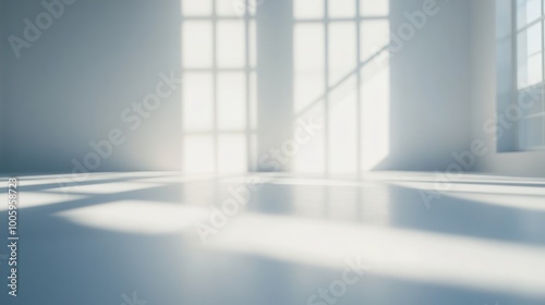 Bright, empty room with sunlight casting shadows on the floor.