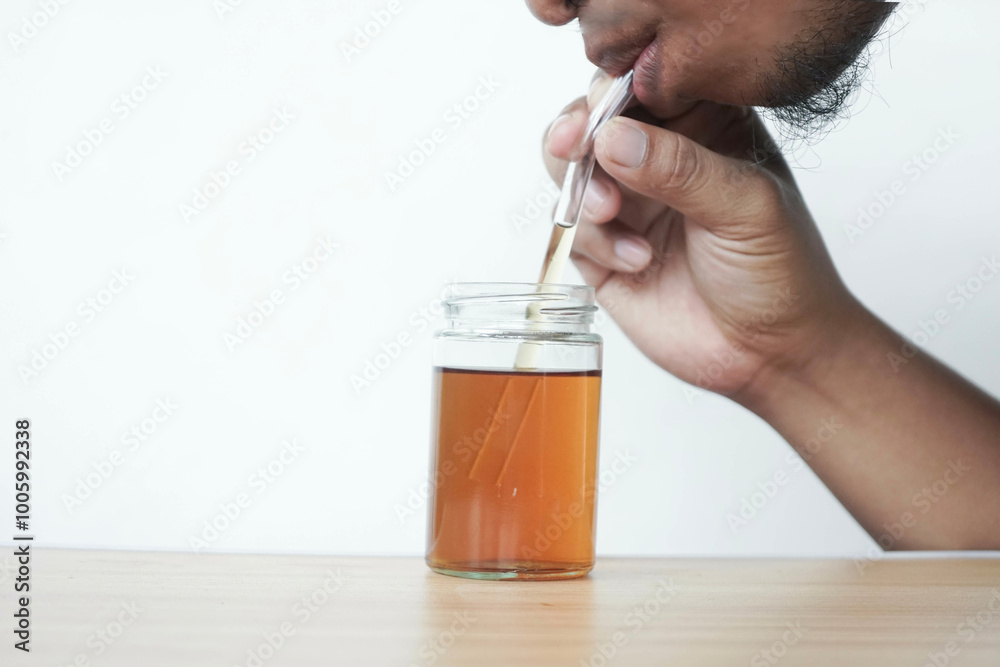 a man is drinking tea using a glass a man is drinking tea using a glass