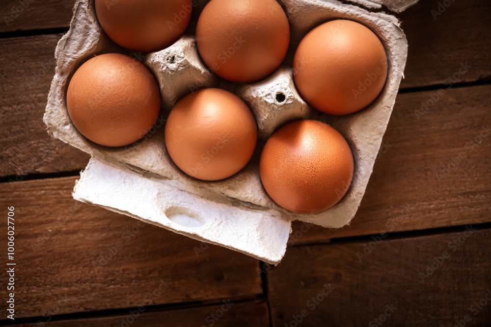 Egg box on a rustic wooden board Egg box on a rustic wooden board