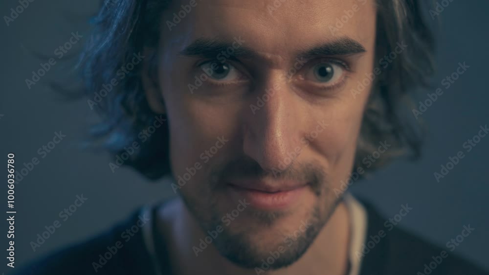 young man with long hair, large expressive eyes, European appearance, smiles, winks with his right eye, becomes serious twice young man with long hair, large expressive eyes, European appearance, smiles, winks with his right eye, becomes serious twice