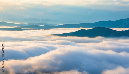 Breathtaking view of mountains with mist and sun rays at sunset.