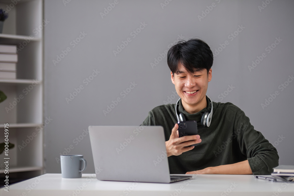 Young Boy Studying Online with Laptop and Smartphone in Modern Home Setting, Smiling and Engaged in Learning Young Boy Studying Online with Laptop and Smartphone in Modern Home Setting, Smiling and Engaged in Learning