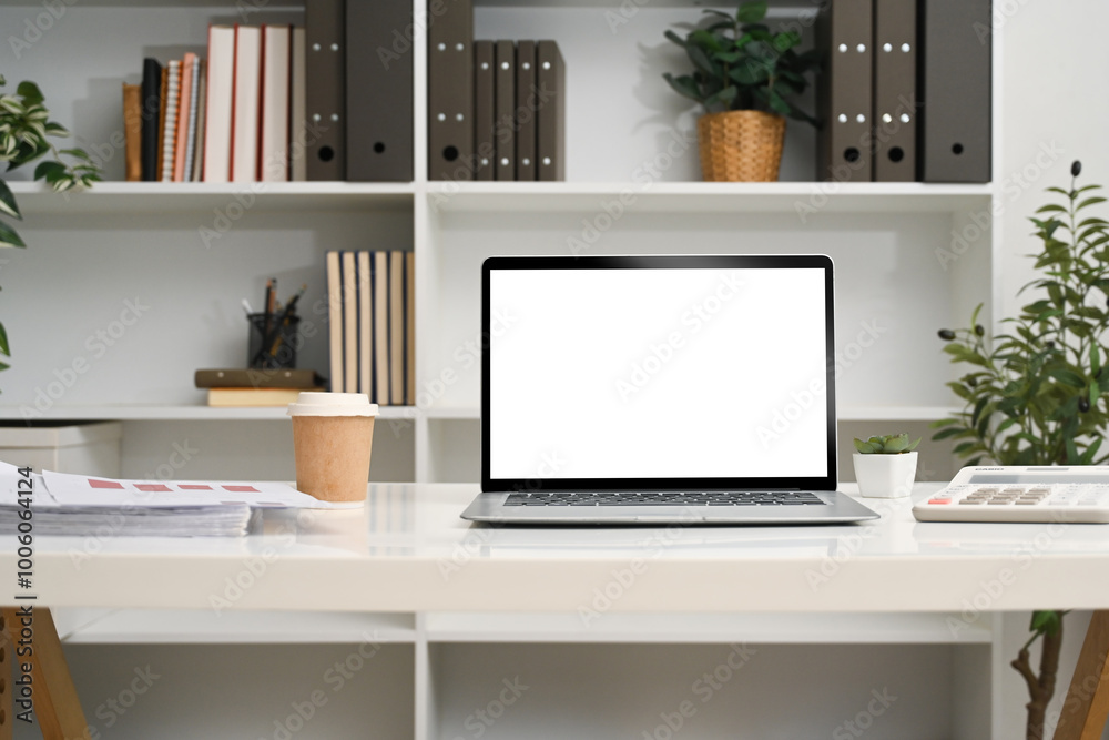 Fototapeta premium Front view laptop with empty display on a desk in front of a bookshelf