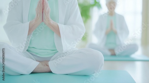 2409_251.elderly patient sitting on a therapy mat while a nurse demonstrates gentle stretching exercises, with bright natural light streaming through a window in a warm clinic environment photo