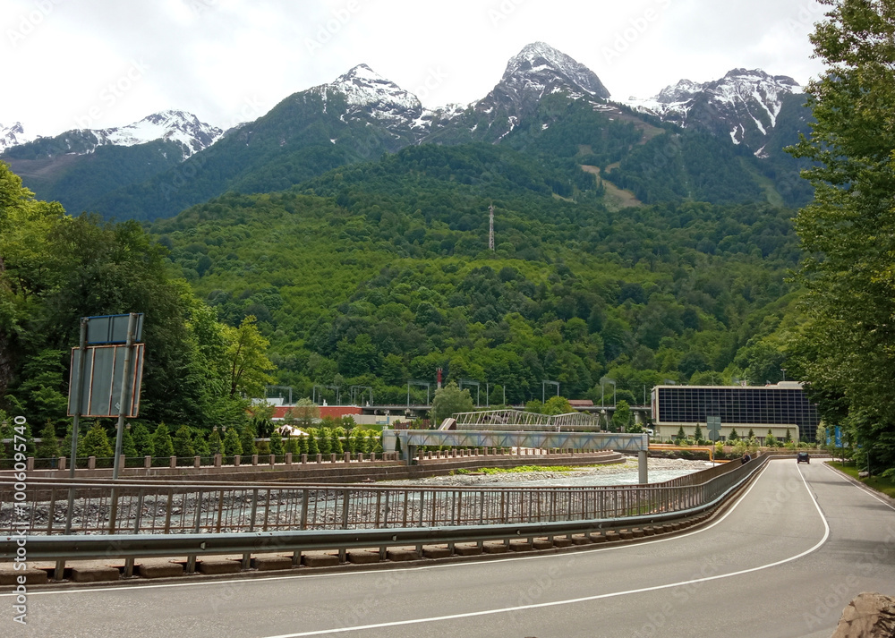 Rosa Khutor embankment, mountains and river. Krasnaya Polyana, Sochi.