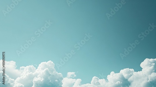 Minimalist Blue Sky with Clouds – A vast, clear blue sky with a few soft, fluffy clouds drifting by, leaving plenty of open space in the center for text overlay 