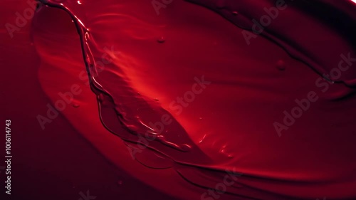 Vivid red liquid waves creating abstract patterns in motion