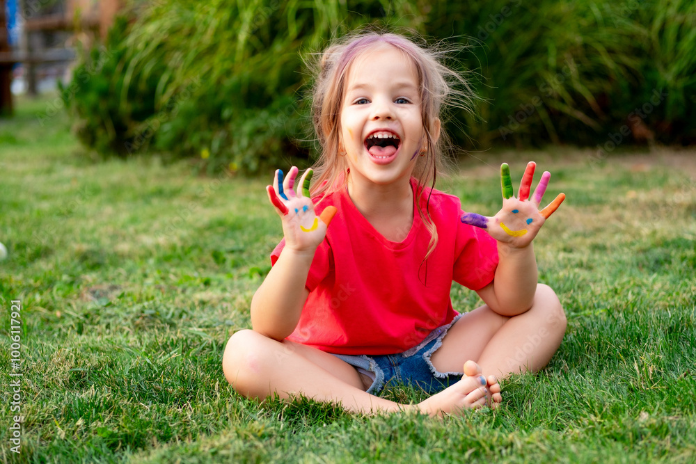 a small child girl with painted fingers in bright colors on her hands in summer on a green lawn, a bright summer photo of a happy child with colorful fingers in colors a small child girl with painted fingers in bright colors on her hands in summer on a green lawn, a bright summer photo of a happy child with colorful fingers in colors