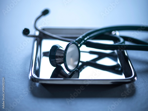 Stethoscope on a metal tray for health check and medical tests. photo