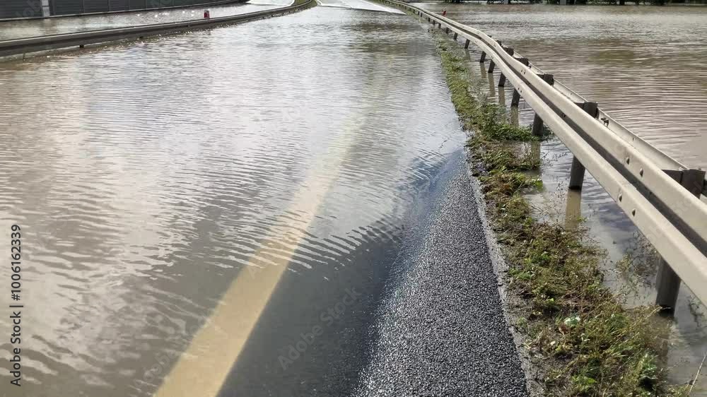 Flooded and impassable national road DK1 due to pool of water at confluence of Rivers Wapienica i Iłownica during flood in September 2024 in Poland in Czechowice Dziedzice - slow motion. Flooded and impassable national road DK1 due to pool of water at confluence of Rivers Wapienica i Iłownica during flood in September 2024 in Poland in Czechowice Dziedzice - slow motion.