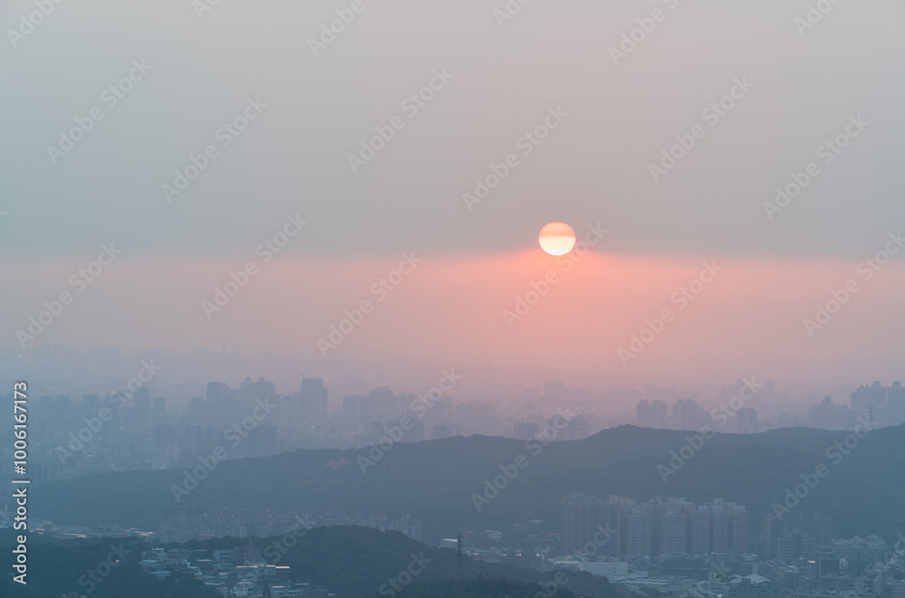 Naklejka premium A breathtaking panoramic view of Taipei City at sunset, with the city skyline and Tamsui River stretching out below. Dading Mountain, Shulin, Taiwan.