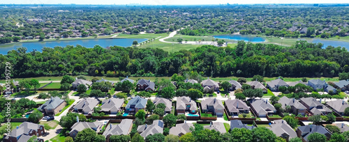 Panorama aerial upscale houses with swimming pool, solar roofing near suburban park creek, lake, pond, lush green urban forest suburb Dallas Fort Worth Metroplex, neighborhood hood Coppell Texas photo
