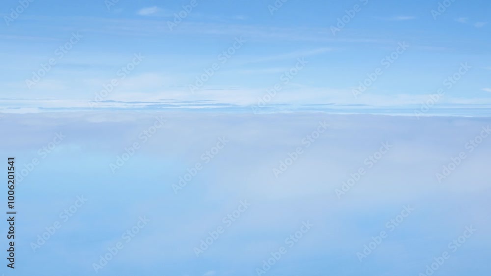 Aerial view above the clouds and sky inspiration concept in cinematic breathtaking aerial flying over white fluffy cloudscape in high altitude sky with fresh clean air and blue skies on background.