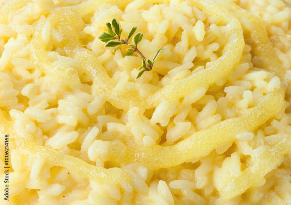 Saffron risotto with melted cheese and thyme garnish Saffron risotto with melted cheese and thyme garnish