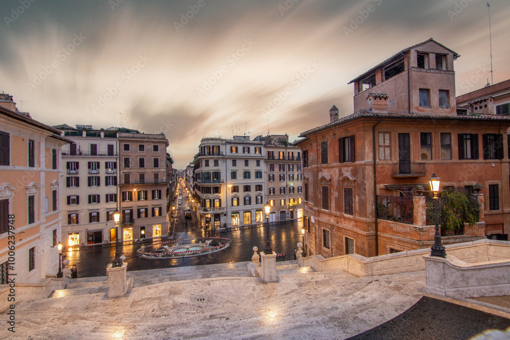 View over a beautiful historic Roman city. At one of the sights, with old buildings in an urban flair. Morning sunrise at the Spanish Steps Scalinata di Trinità dei Monti, Rome, Italy View over a beautiful historic Roman city. At one of the sights, with old buildings in an urban flair. Morning sunrise at the Spanish Steps Scalinata di Trinità dei Monti, Rome, Italy