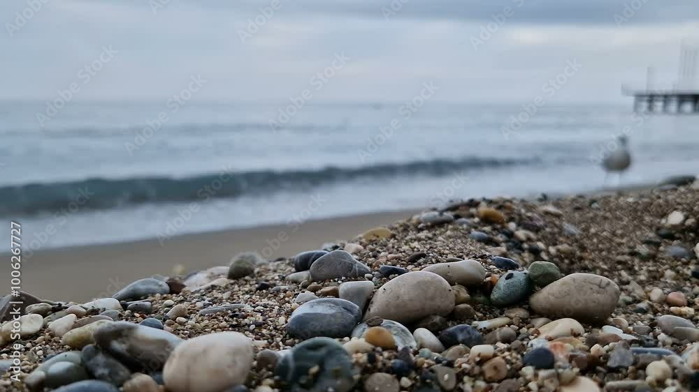 Waves in the sea. A pebble beach. The shore of the sea beach with waves in the ocean. Waves in the sea. A pebble beach. The shore of the sea beach with waves in the ocean.
