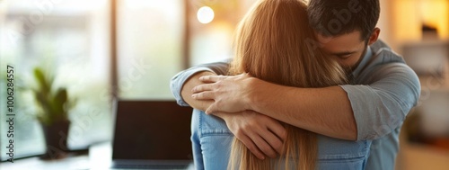 A couple embraces warmly in a cozy indoor setting during golden hour