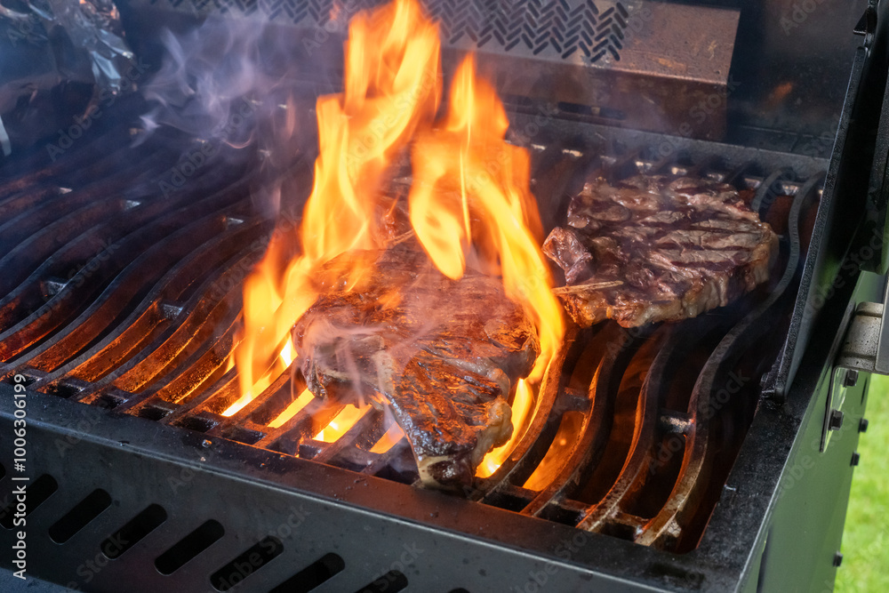 Three steaks cooking on a barbque Three steaks cooking on a barbque